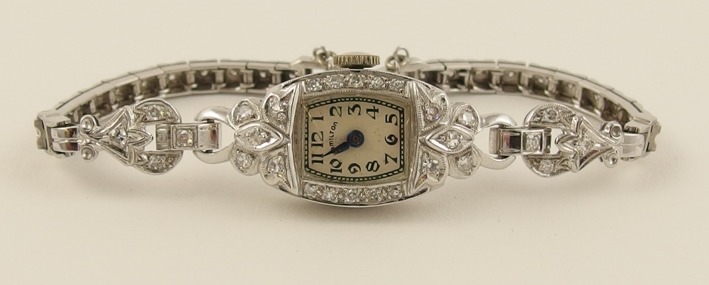 A ladies diamond watch by Hamilton with a platinum head and 14ct white gold strap, set throughout