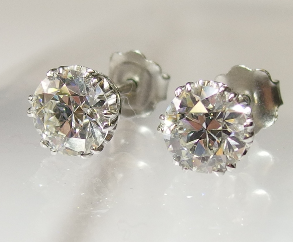A pair of substantial diamond stud earrings each diamond is approximately 2.00cts, in classic split