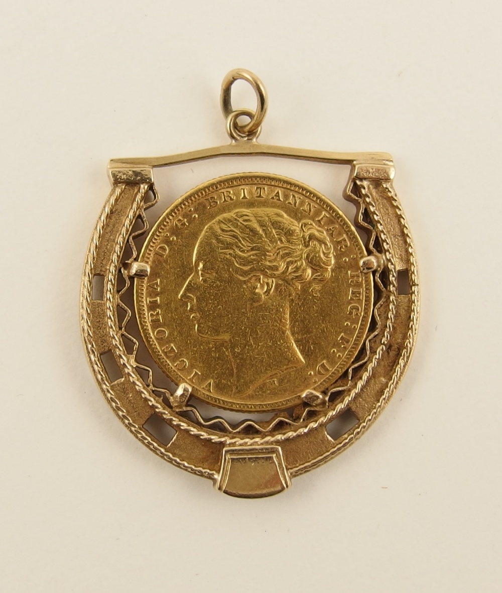 An 1876 gold sovereign  in a 9ct decorative horseshoe mount, approximate total weight 12.8gms