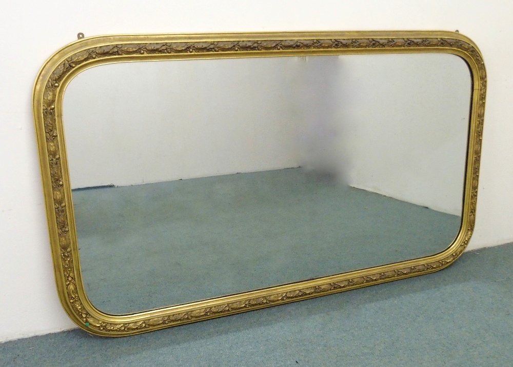 A Victorian giltwood overmantel mirror the frame decorated with carved acanthus leaves in foliage,