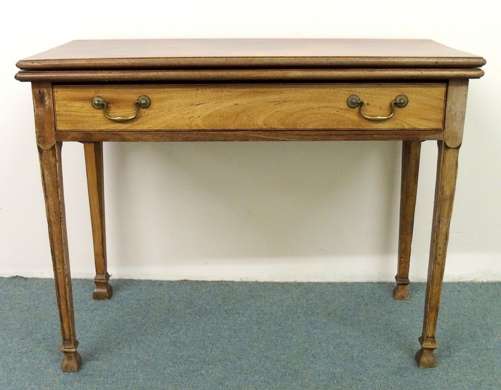 A 19th Century mahogany tea table having a fold over top, above a single drawer with brass handles,