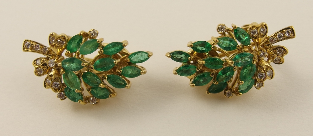 A pair of emerald and diamond earrings in 18ct yellow gold, fashioned as a floral spray, with