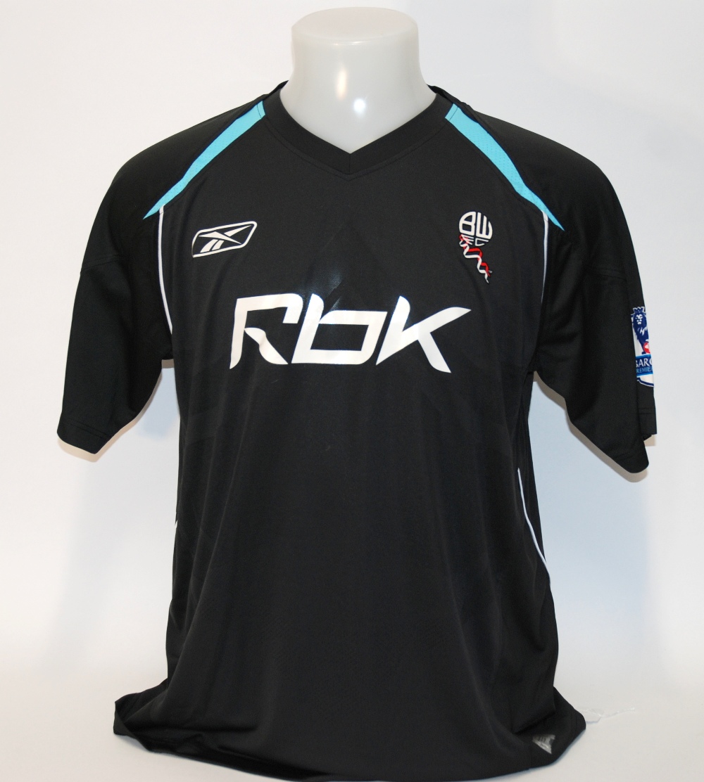 A black Bolton Wanderers short-sleeved shirt No.15, with v-neck collar and sponge badge, the reveres