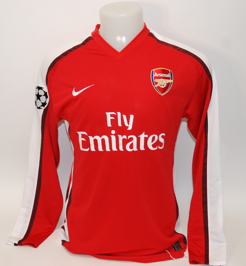 A red Arsenal shirt No.4, with v-neck collar and embroidered cloth badge, inscribed Arsenal, the