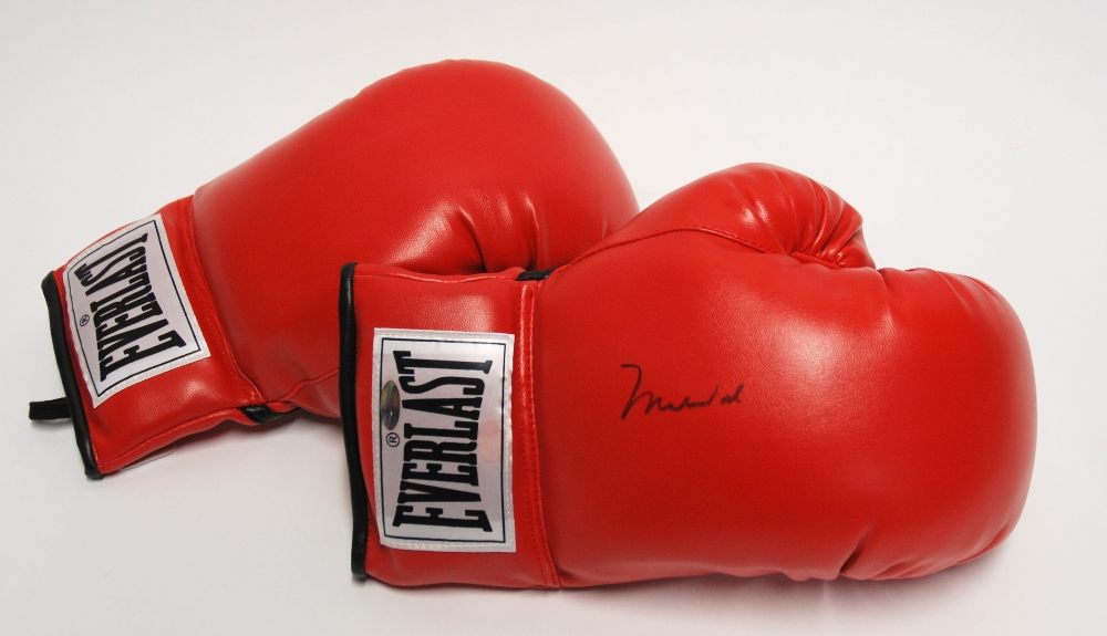 A pair of Everlast 10oz boxing gloves the right glove autographed by Muhammad Ali, with