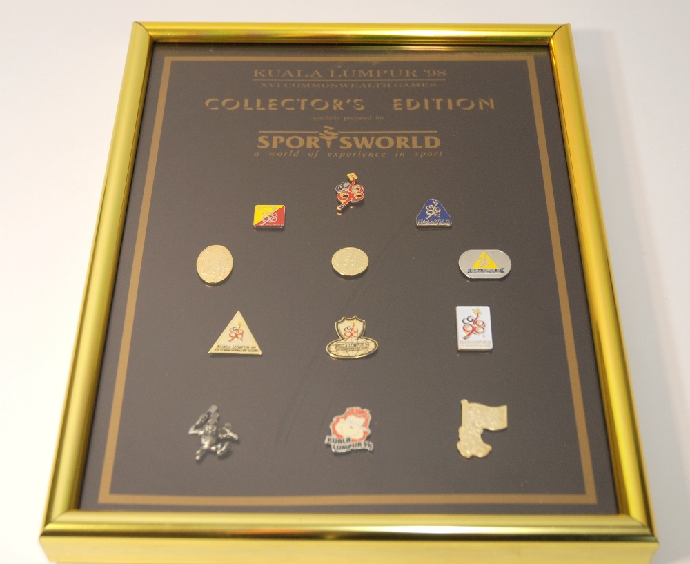 A framed display of Kuala Lumpur 1998 XVI Commonwealth Games lapel badges two other games lapel