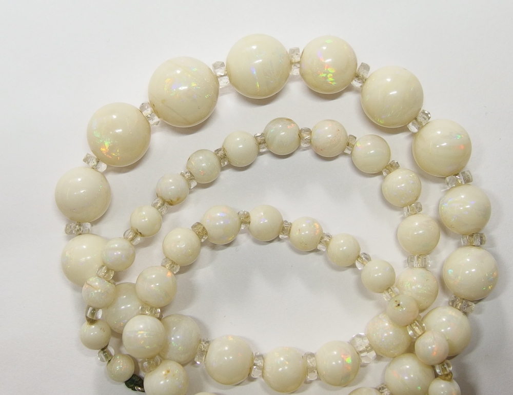 A string of white opal beads opal beads range in size from 11.4mm to 4.4mm forty nine in total,