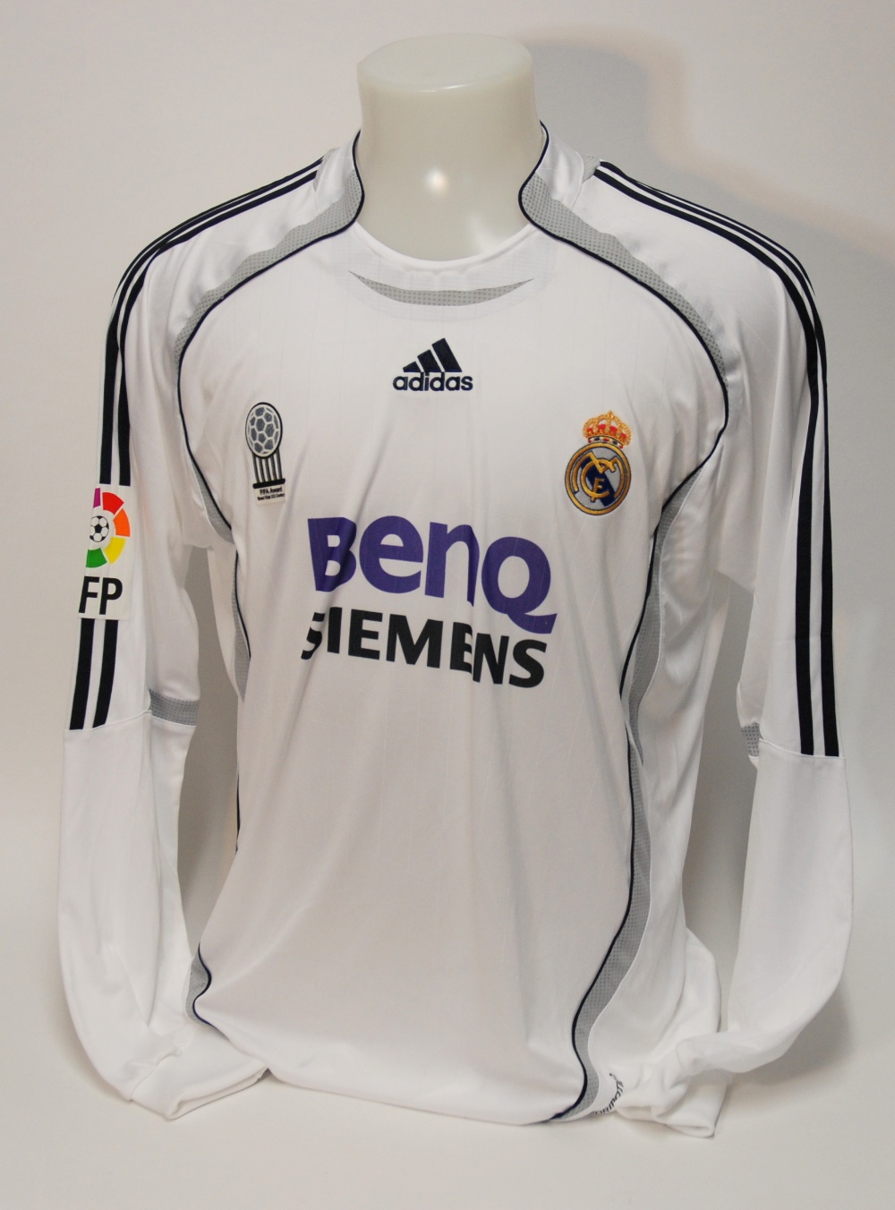 A white Real Madrid shirt No.23, with crew-neck collar and embroidered badge, inscribed FCM, with