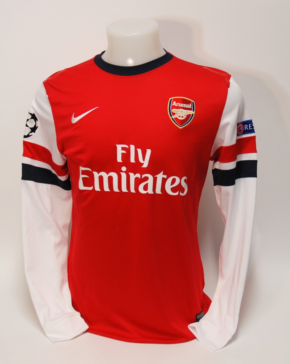 A red Arsenal shirt No.15, with crew-neck collar and embroidered cloth badge, inscribed Arsenal, the