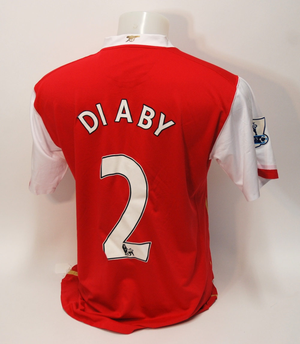 A red Arsenal short-sleeved shirt No.2, with crew-neck collar and embroidered cloth badge, inscribed