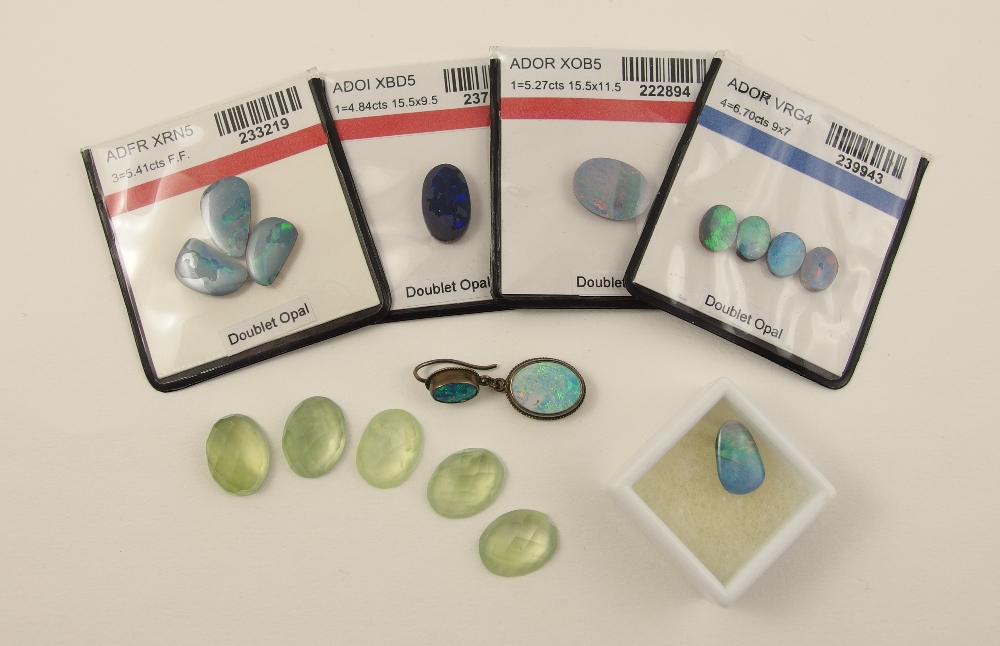 A collection of gem stones four packets of opal doublets, ovals and freeform shapes, together with a