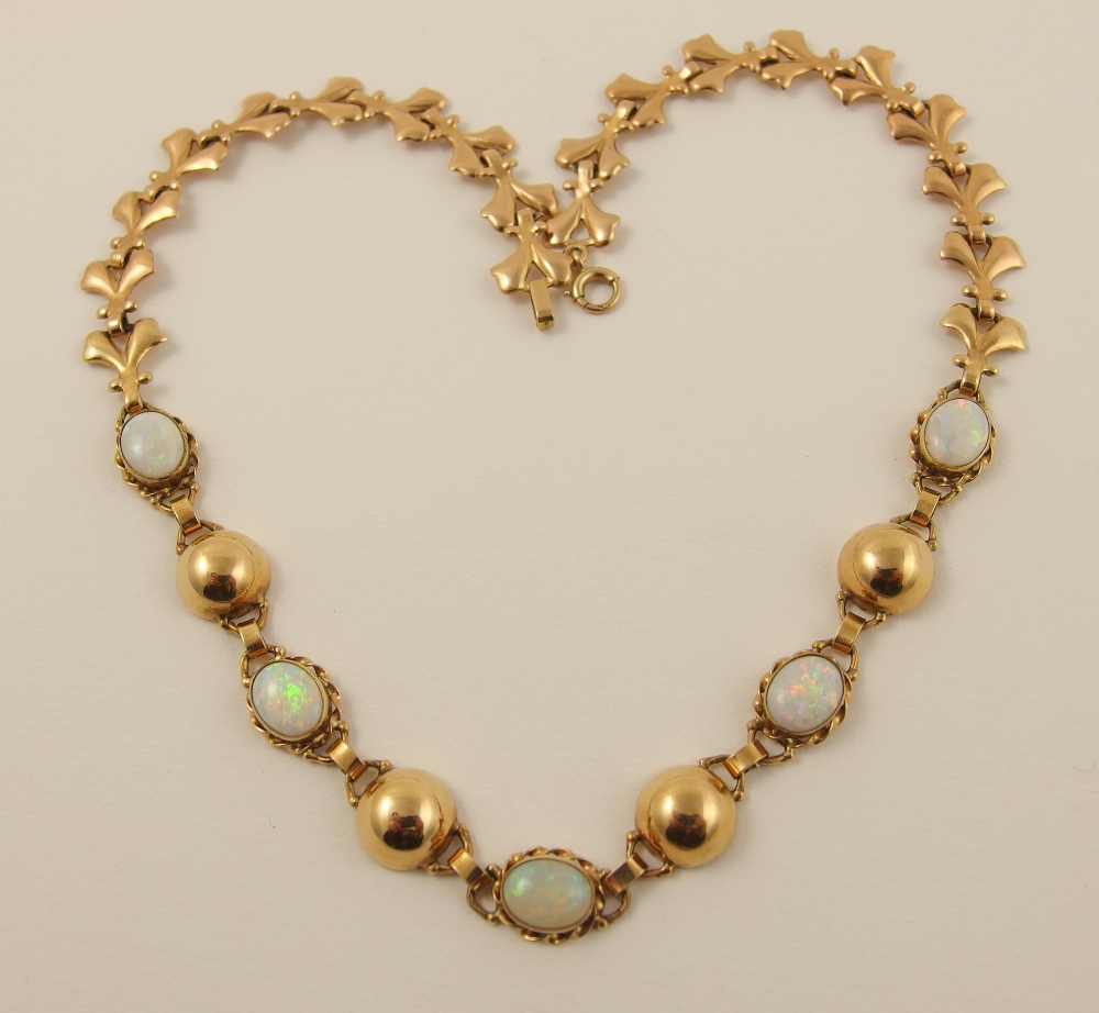 A 14ct opal necklace set with five oval cabouchon white opals of approx 9mm x 7mm on a decorative