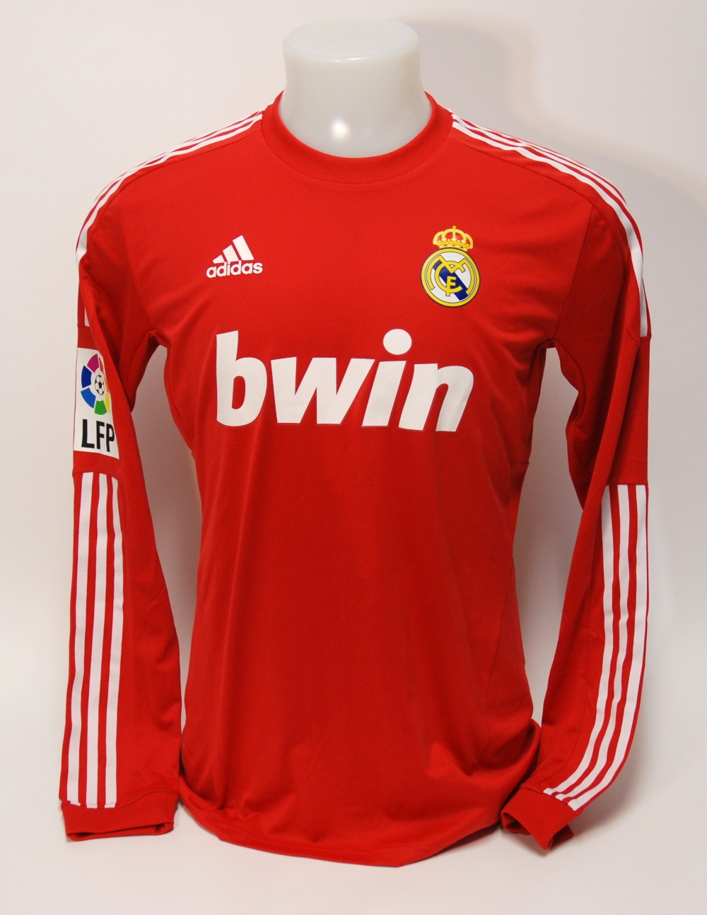 A red Real Madrid shirt No.7, with crew-neck collar and printed badge, the reverse lettered Ronaldo,