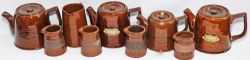 A nice collection of brown earthenware items comprising: a pair of Great Northern Railway Teapots; a