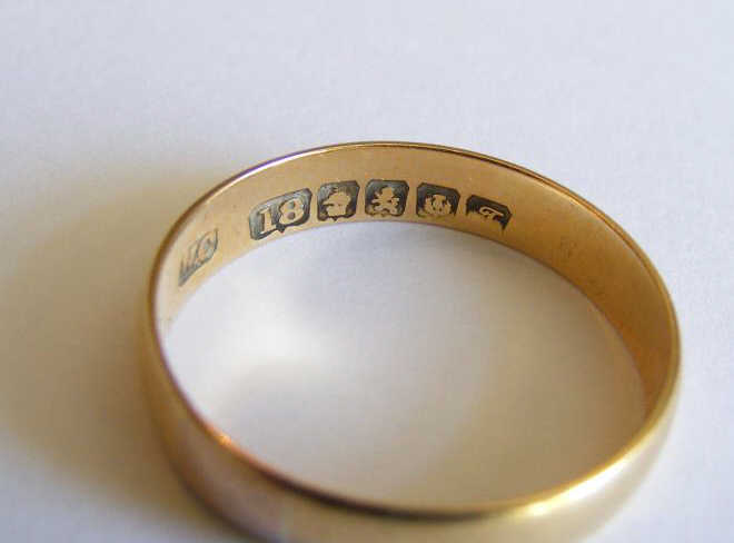 A hallmarket 18ct gold Wedding Band together with a finer yellow metal ditto stamped 18ct. (2)
