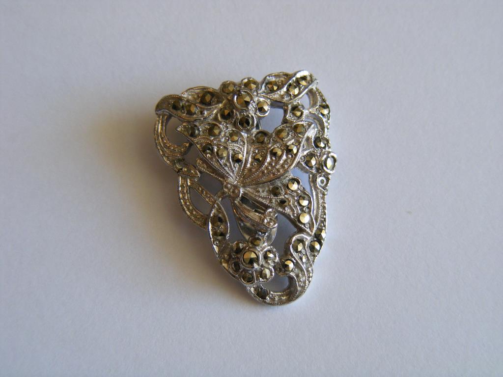 A marcasite-set white metal Brooch formed as a Butterfly on a Leaf.
