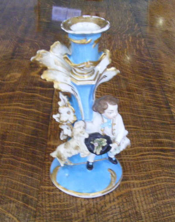 A C19th Parisian Candlestick formed as a child with a goat.