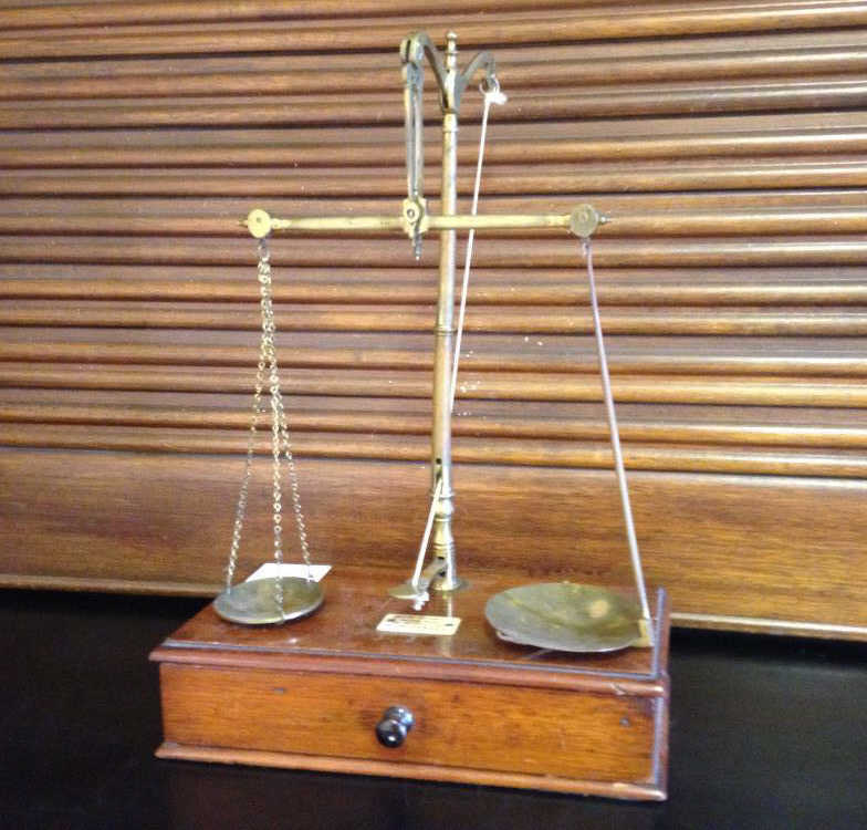 "A set of Balance Scales with various small weights, mounted with maker plaque for J Nesbit,