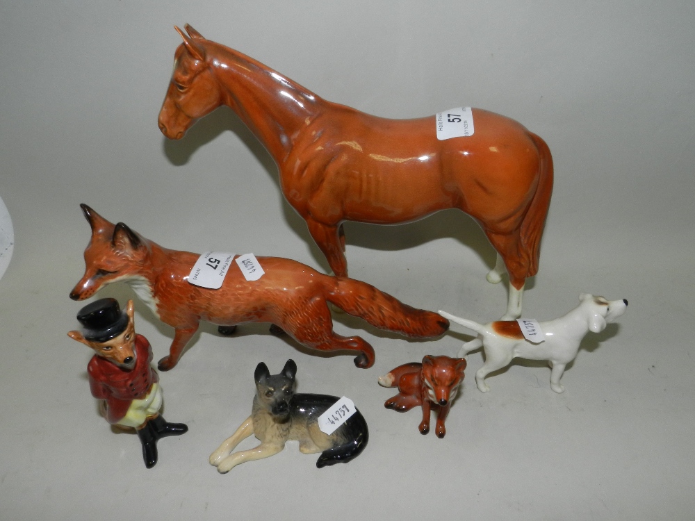 Two Beswick models of foxes, one large, modelled standing, the other small, modelled seated,