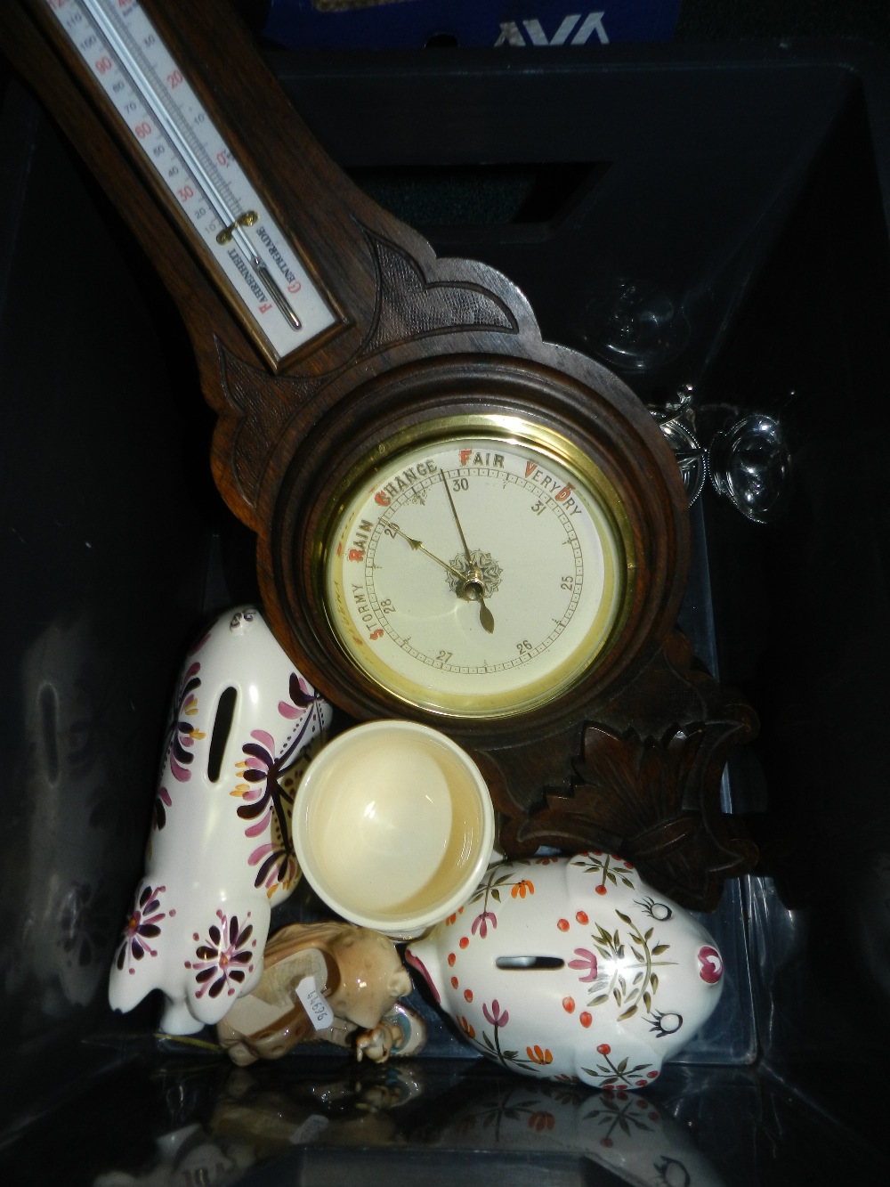 A small collection of sundries including an aneroid barometer, money banks etc