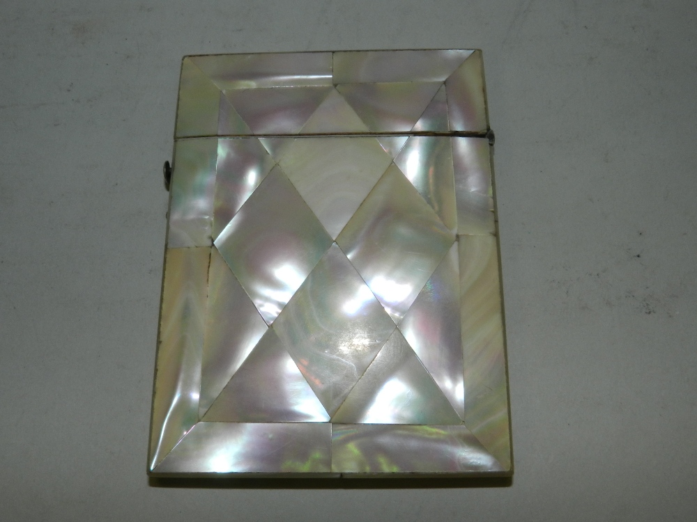 A mother of pearl card case.*