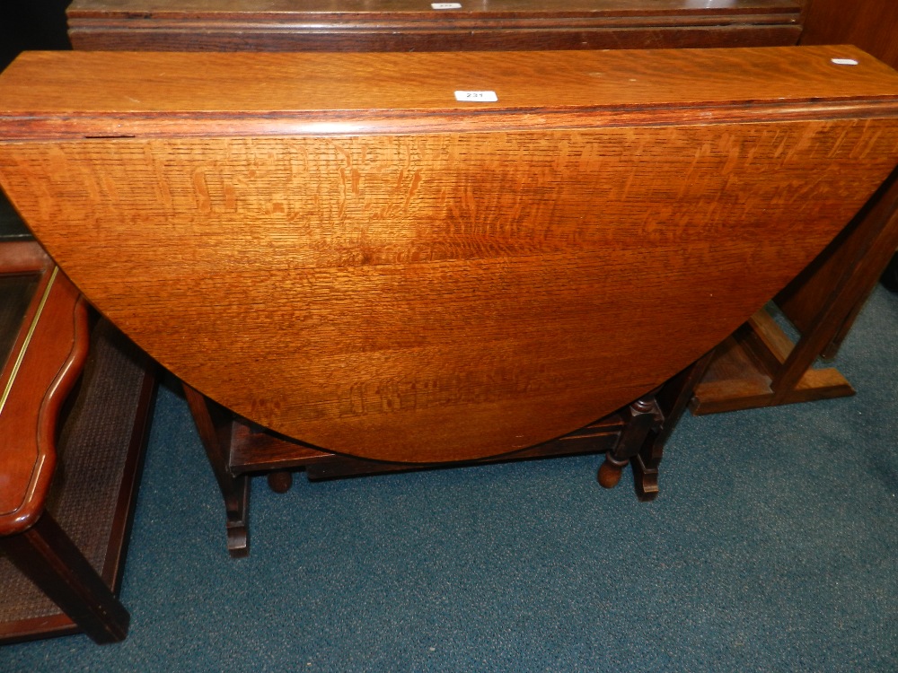 A 1930's oak Sutherland type oval occasional table.