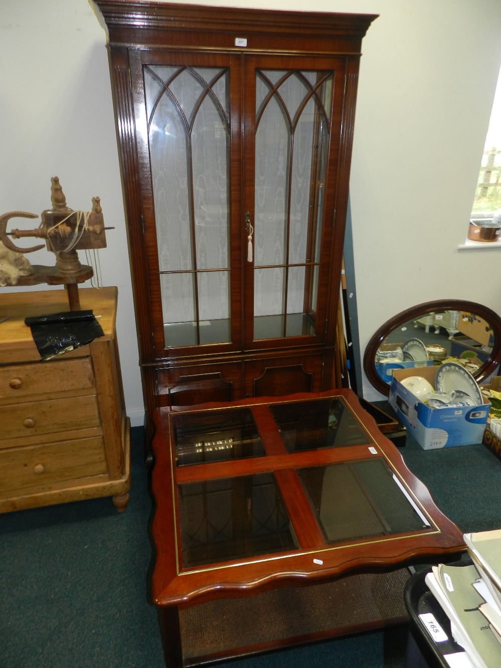 A modern floor standing high china display cabinet with gothic arched glazing bars along with a
