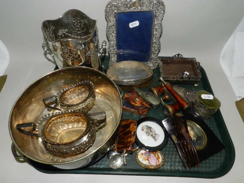 A silver plated bottle coaster, together with a silver mounted photograph frame, a silver mounted