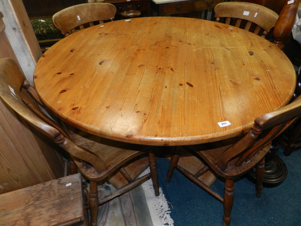 Four Victorian lathe and bar back kitchen chairs along with a modern pine pedestal breakfast table.