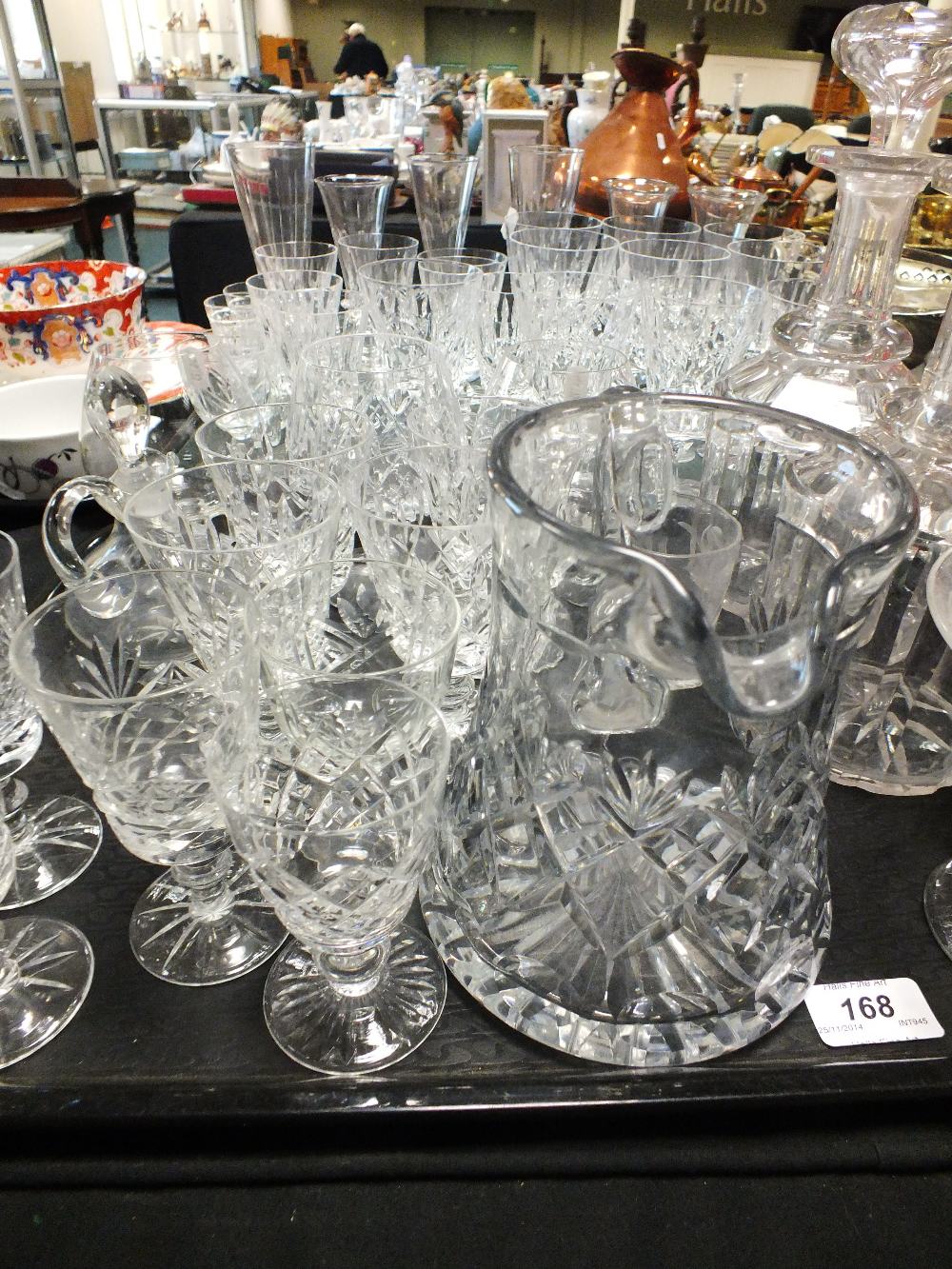 Two trays of cut glassware to include champagne flutes, brandy balloons, wine and liqueur glasses, a