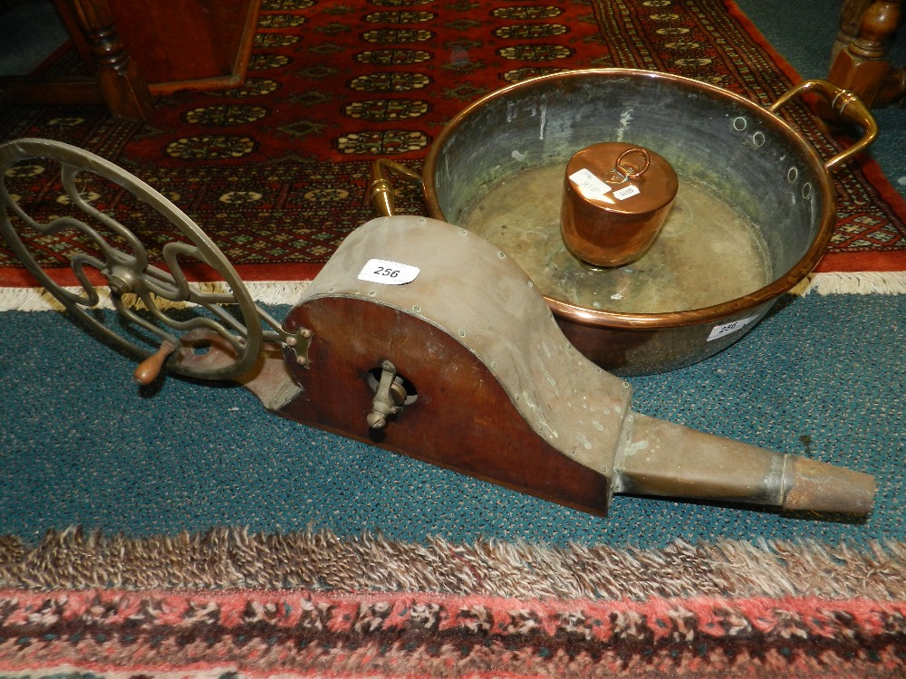 A Benham & Sons copper mould, a copper two handled pan and a set of mechanical bellows.