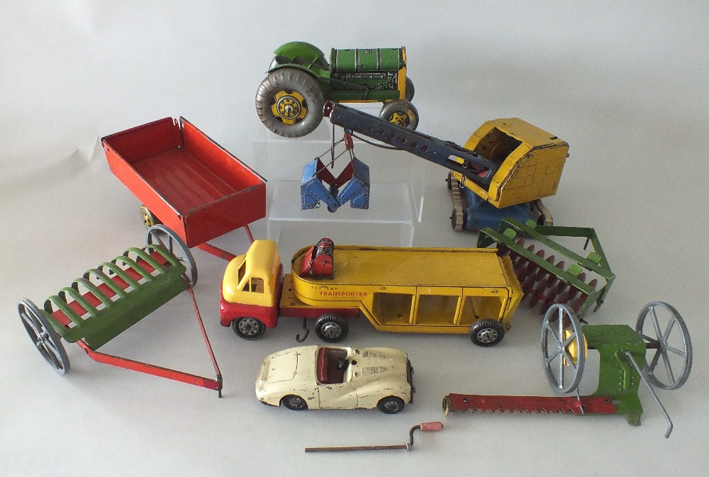 A group of tin plate toys, to include a Mettoy post-war clockwork tractor with farm implements