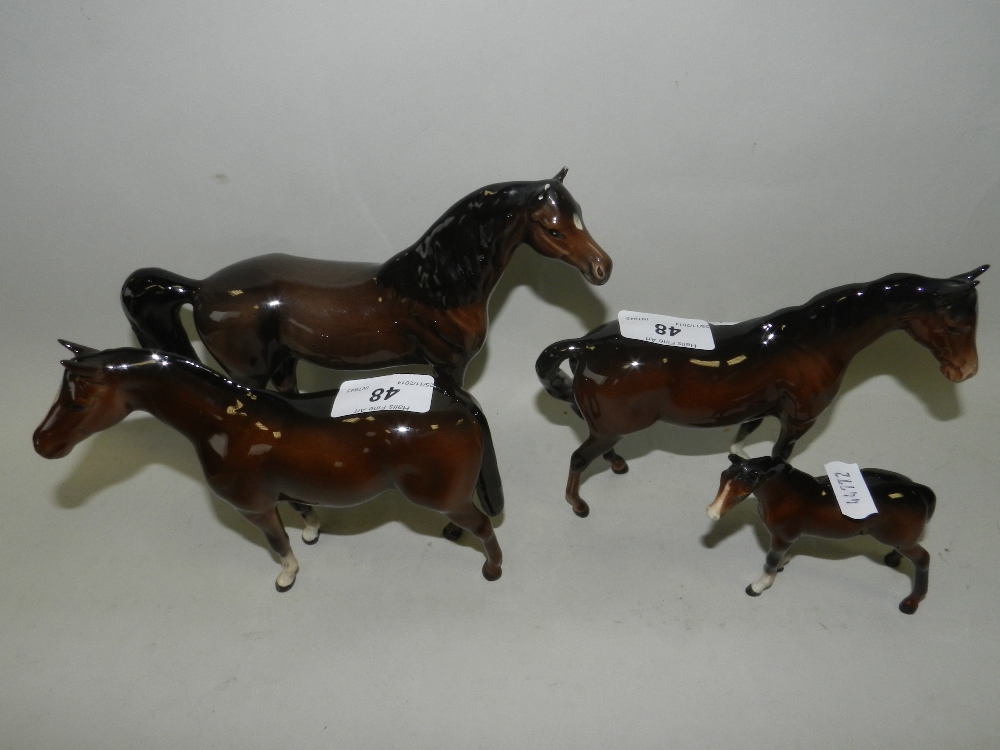 Four Beswick dark brown models of horses, including a foal (one a.f)