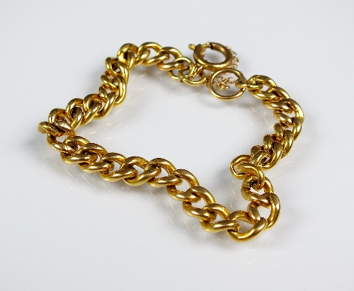 An 18ct gold curb link bracelet, with bolt ring clasp stamped '9ct', with attached safety chain,