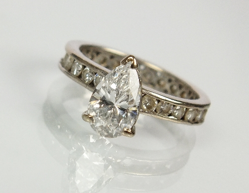 A pear shaped solitaire diamond ring, the pear shaped diamond claw set in white metal to a diamond