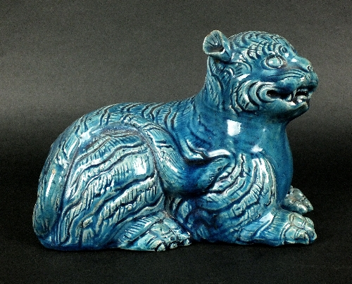 A Chinese turquoise glazed figure of a cat, possibly 19th century,  modelled in repose with its tail