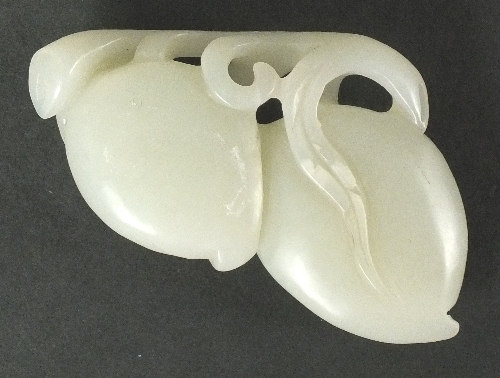 A Chinese mutton fat jade carving of two peaches growing on a branch, 20th century, the ripening
