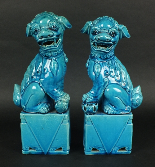 A pair of Chinese porcelain 'Fu' dogs, 20th century, each with all-over turquoise glaze, modelled