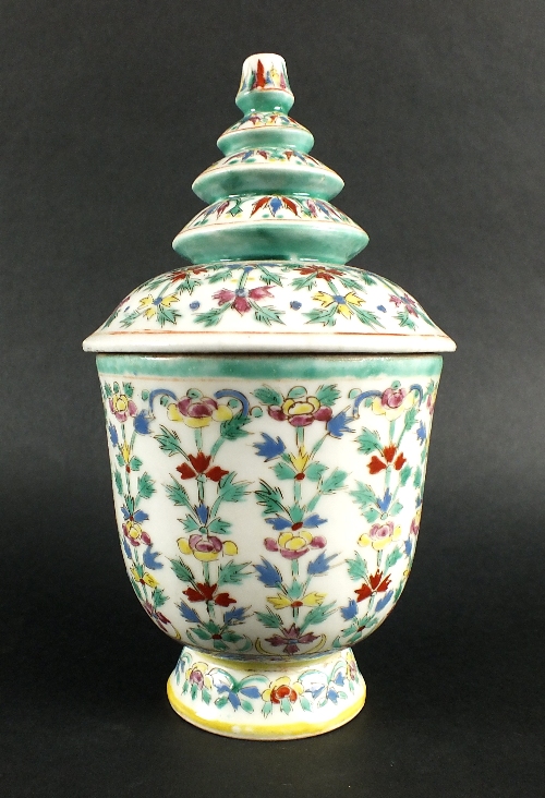 An Indonesian market jar and cover, 20th century, the cover of distinctive tiered pagoda form,