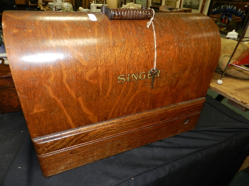An oak cased Singer sewing machine