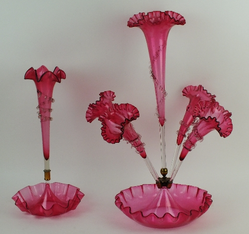 A late Victorian cranberry glass epergne, the large central stem flanked by three individual