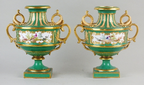 A pair of English porcelain vases, lacking covers, 19th century, of elaborate twin handled form,