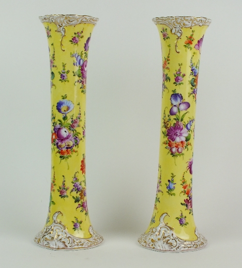 A pair of early 20th century Dresden porcelain sleeve vases, bright yellow grounds printed and