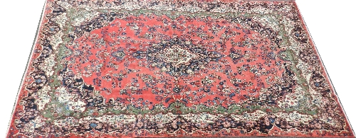 A large Caucasian designed red and blue ground carpet with large central stylised motif on a red