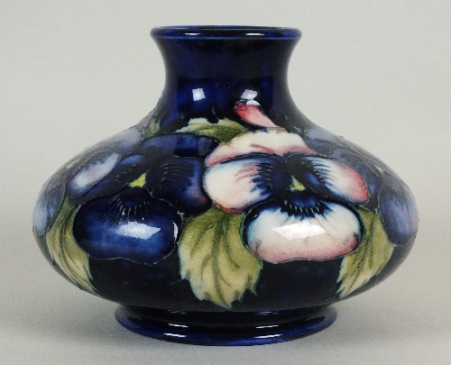 A Moorcroft squat bulbous vase, circa 1920-30, decorated with pink and purple pansies against a dark