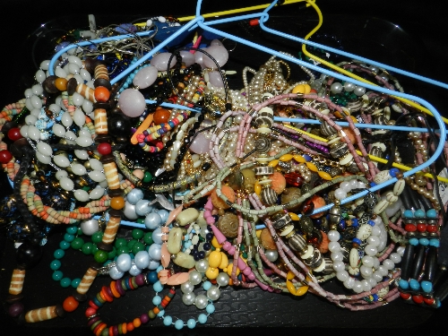 A large collection of various pieces of costume jewellery to include beaded necklaces etc.