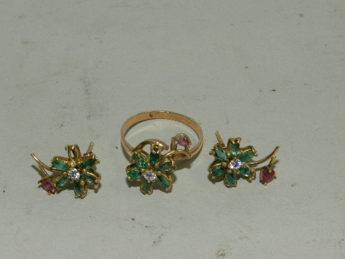 A yellow metal diamond green stone and garnet set flowerhead ring together with a pair of matching
