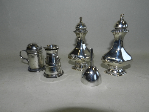 A pair of silver pedestal pepperettes, together with a novelty silver pepperette in the form of a