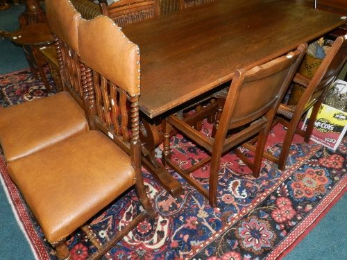 An oak refectory type table; four linen fold chairs; a pair of oak chairs