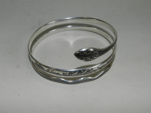 A north African silver and niello snake arm bangle initialled on the inside NG
